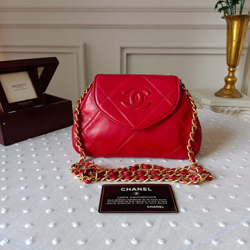 Chanel 1990s Vintage Crescent Bag in rare red lambskin. Includes original card and hologram (matching serial 1147112). Light surface wear consistent with B-grade; chain and interior pristine